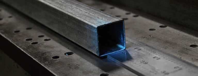 Square shaped steel tube resting on a ruler