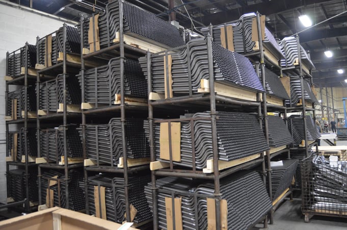 A shelf full of stainless steel tubes