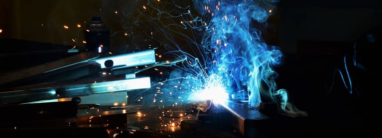 Bright sparks and smoke from a welder