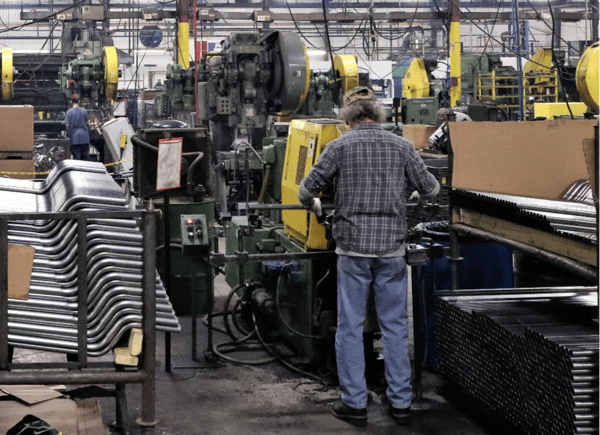 Factory workers in the steel tube production process