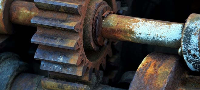 A rusted gear in a larger steel assembly