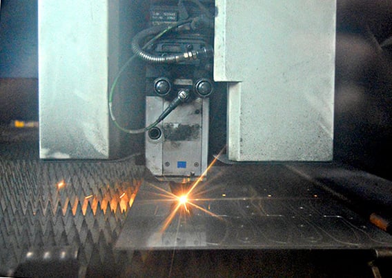 Laser cutting machine cutting a sheet of metal