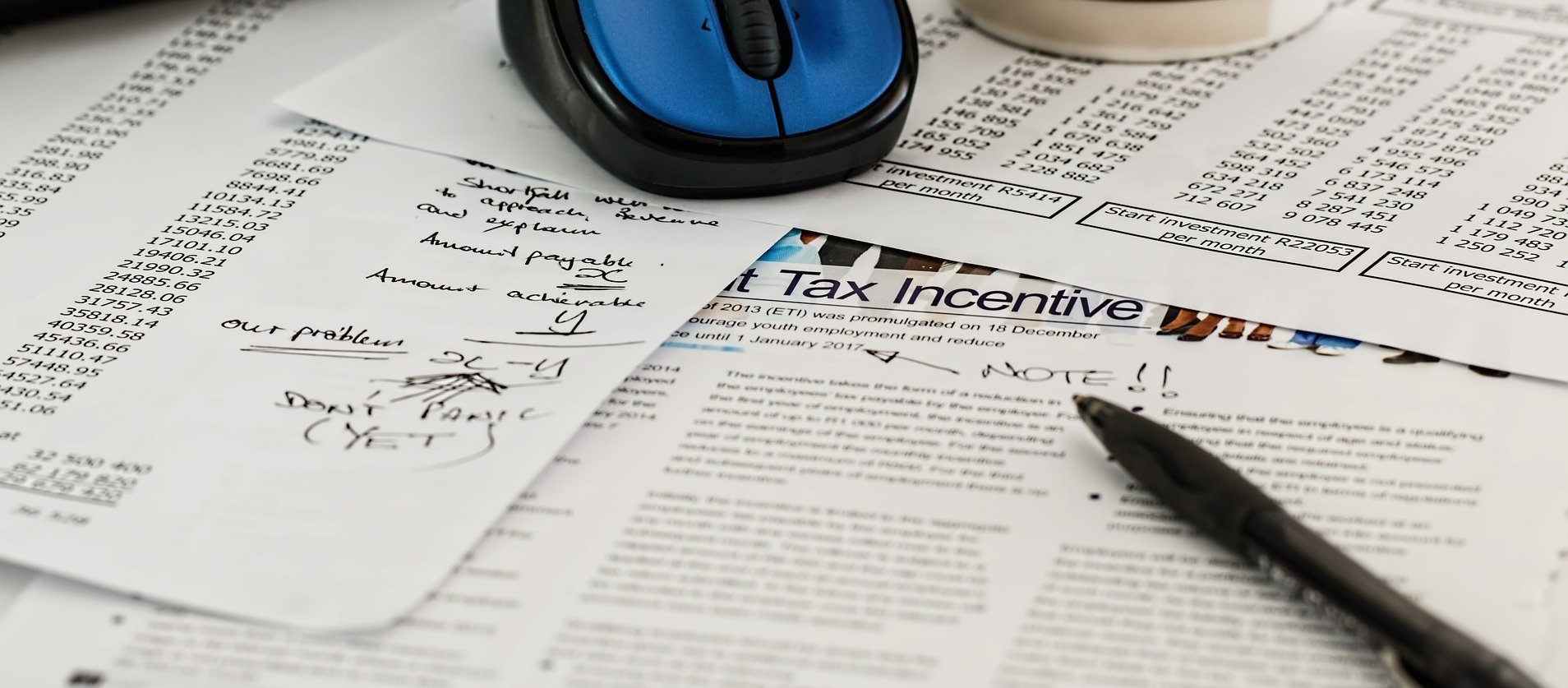 Stack of tax documents with handwritten notes