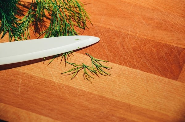 A sharp blade cutting fresh herbs