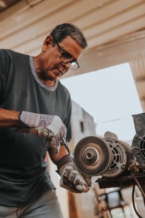 A man sharpening a steel knife