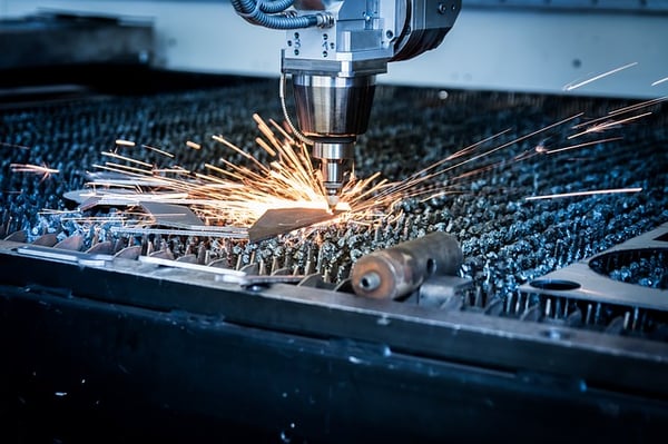 Laser cutter cutting metal and producing sparks