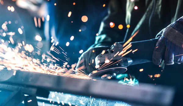 Sparks flying as an engineer cuts through metal