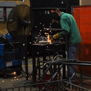 Engineer welding metal materials and creating sparks