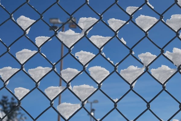 Snow gathering on a chain link fence